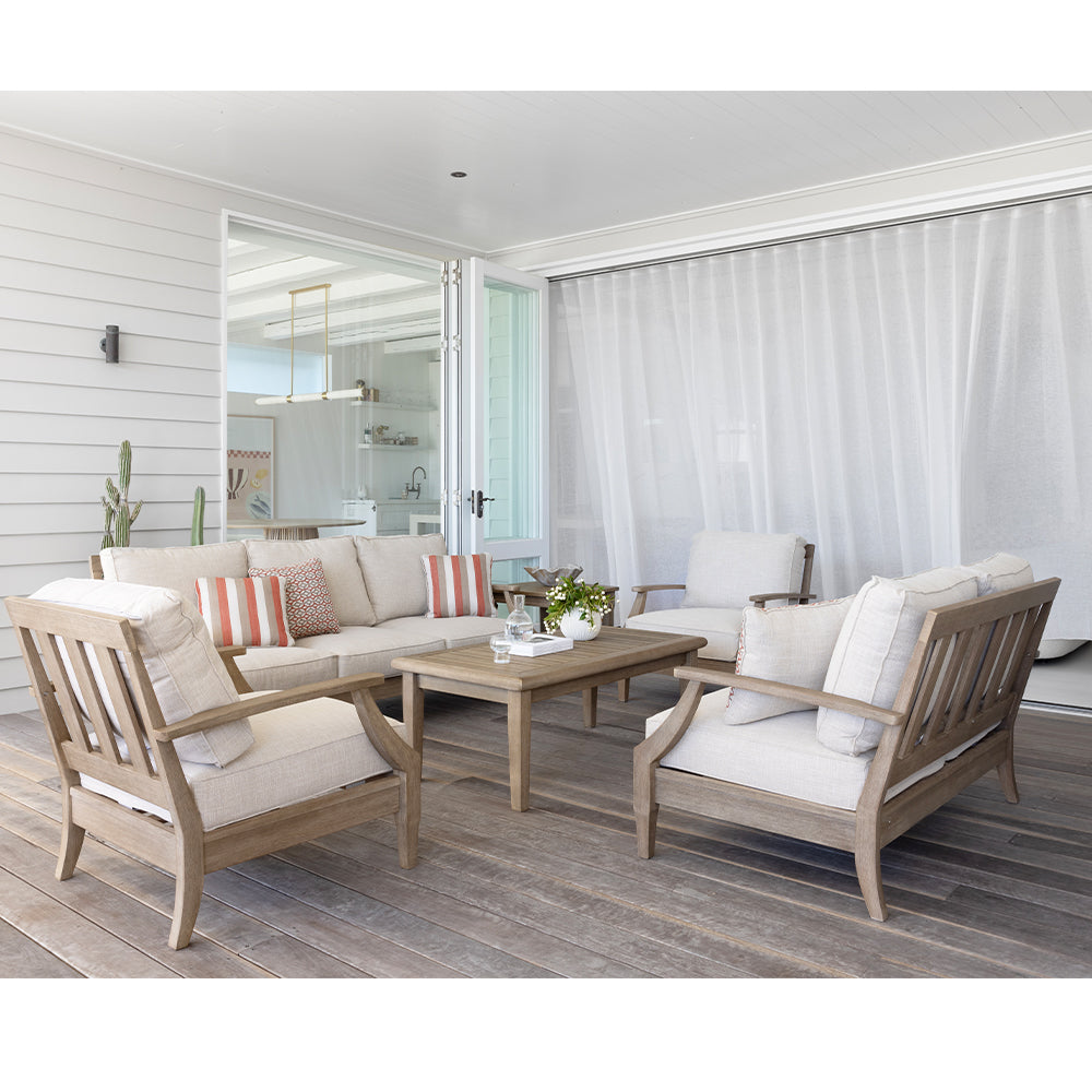 a wooden outdoor lounge set with wooden coffee table on a patio