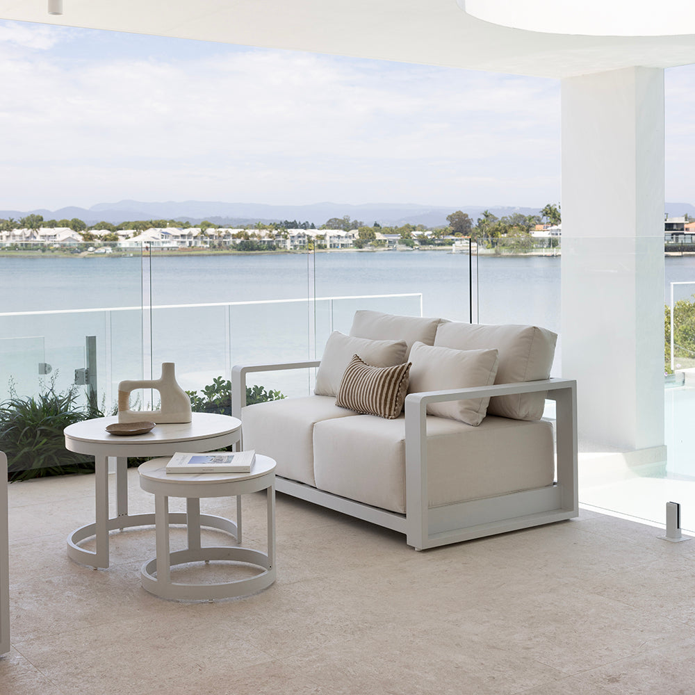 A small patio featuring a bench with built-in storage and a compact dining table