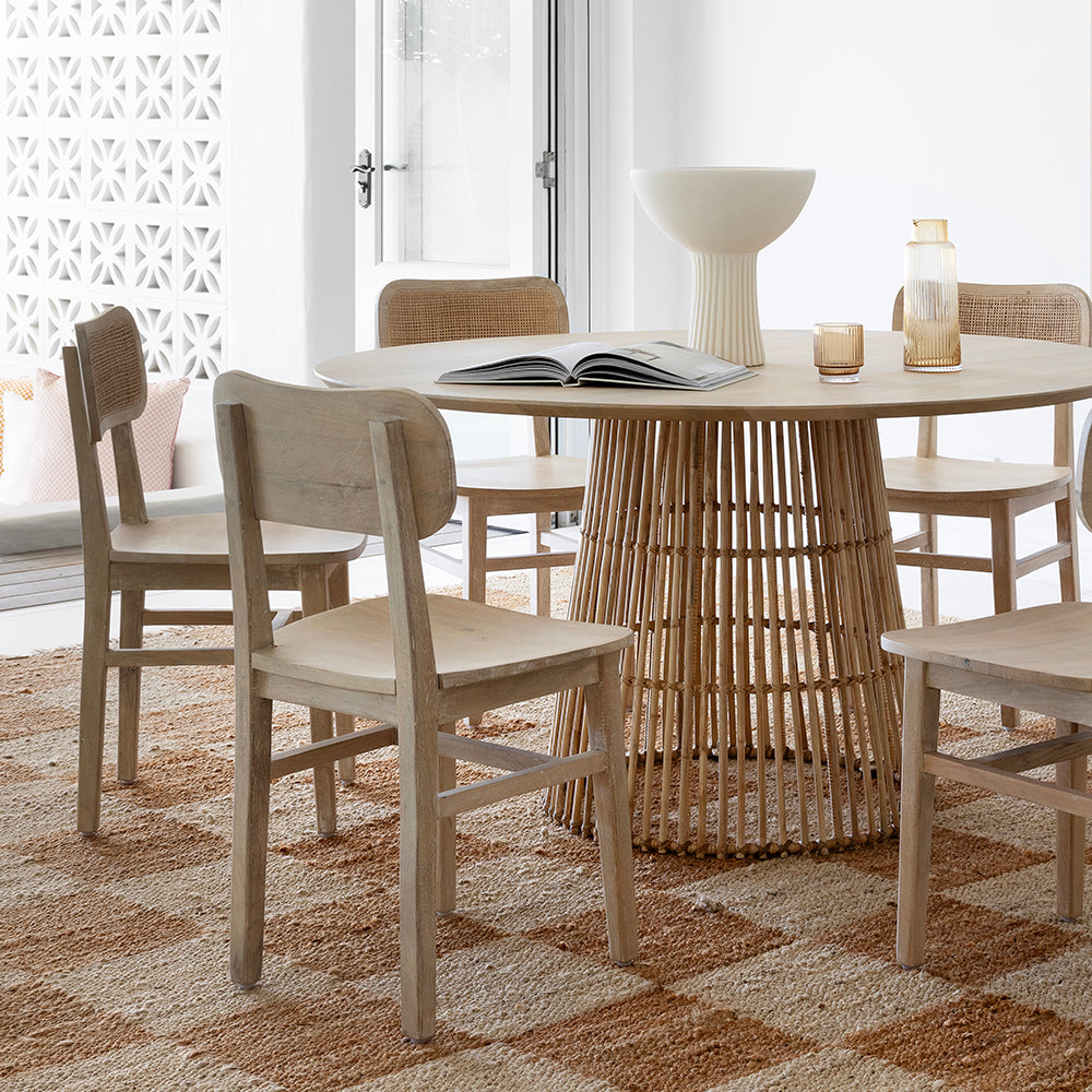 Dining table with mismatched chairs in cohesive neutral tones