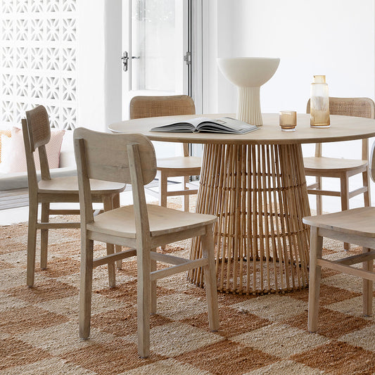 Dining table with mismatched chairs in cohesive neutral tones