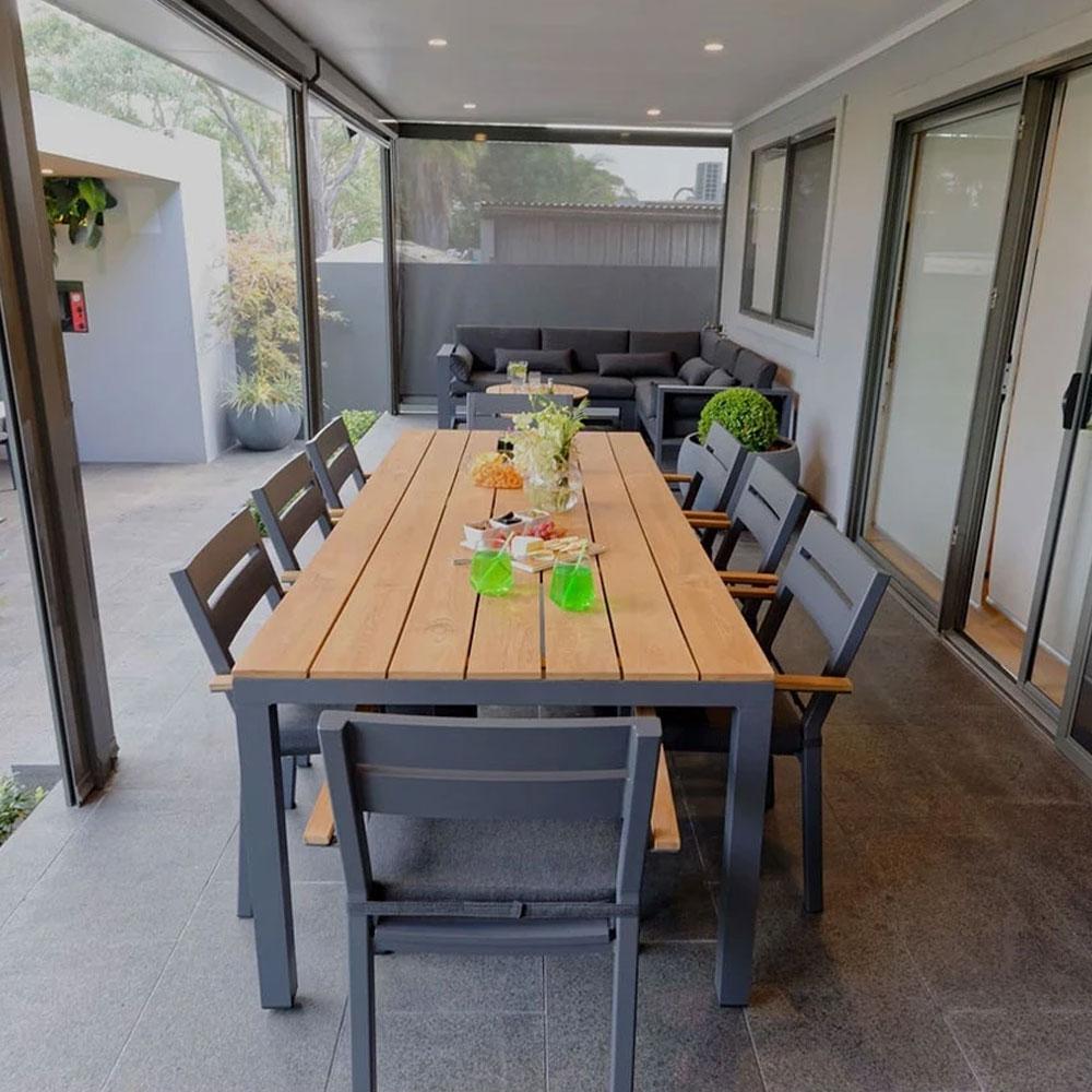 Teak outdoor dining table on a stylish patio